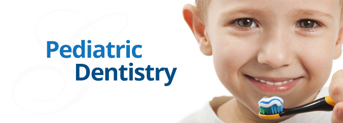 Pediatric Dentistry, boy smiling and holding a toothbrush